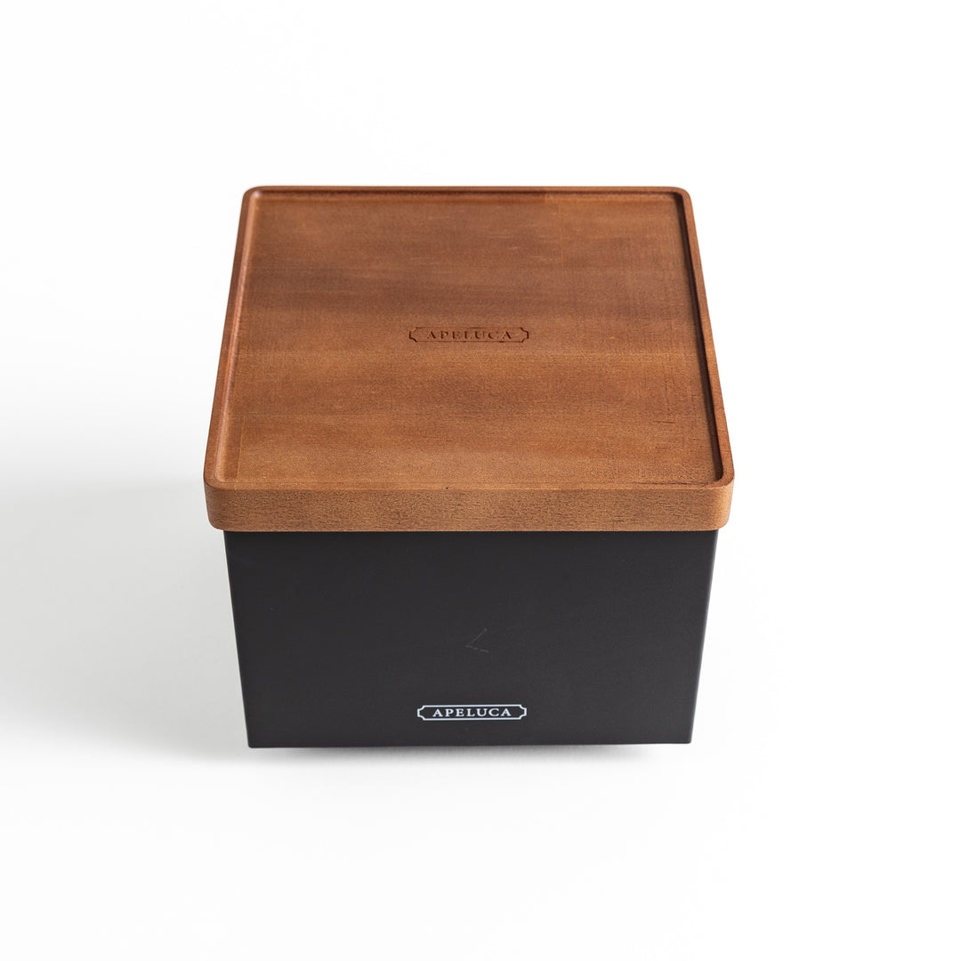 A stylish wooden box placed on a bright white surface, highlighting its elegant look.