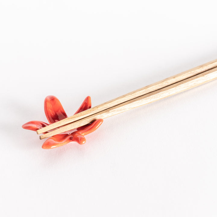 Close-up of the maple leaf chopsticks rest with chopsticks resting across it.