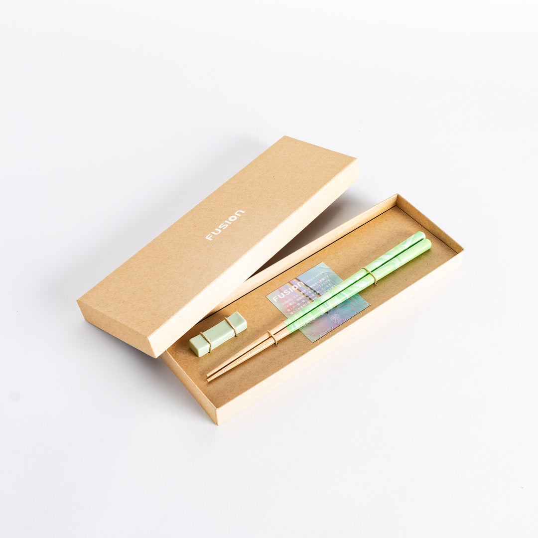 The Mint Whisper Fusion Chopsticks set, beautifully packaged in a sleek box with matching chopstick rests, offering a stylish and sophisticated dining experience.