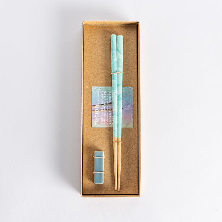 Elegant aqua chopsticks in a gift box, featuring a marbled design and a pair of matching chopstick rests.