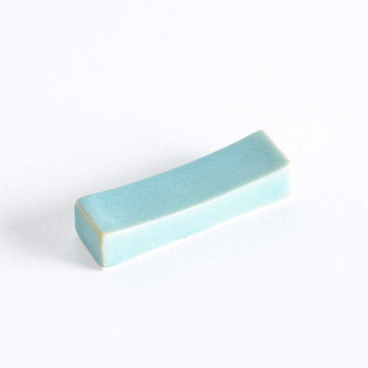 Elegant blue ceramic chopstick rest with a smooth surface, featuring a sleek design and subtle color variations.