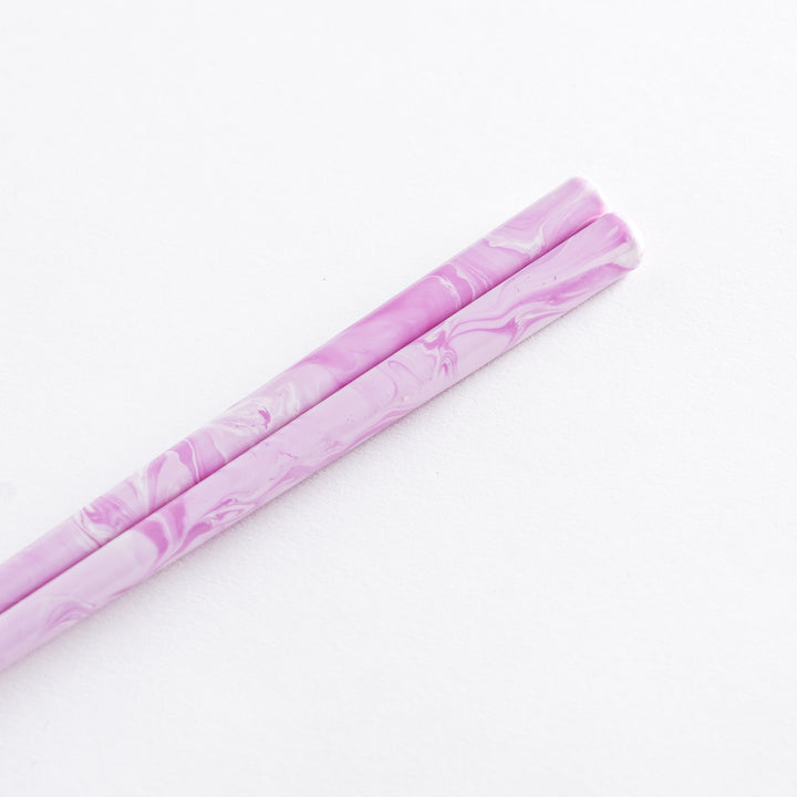 Close-up of Lavender Breeze Fusion Chopsticks on rest, displaying soft pastel pattern and rosybrown color.