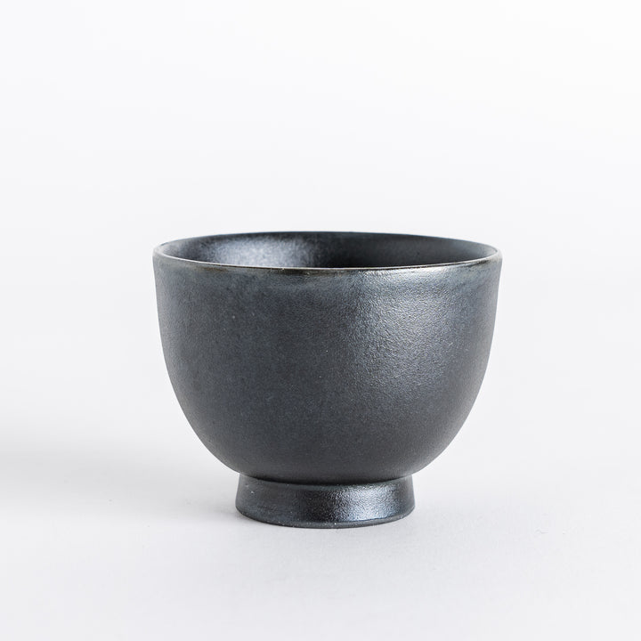 Matte black teacup with a simple, elegant design and a smooth finish, perfect for enjoying tea.