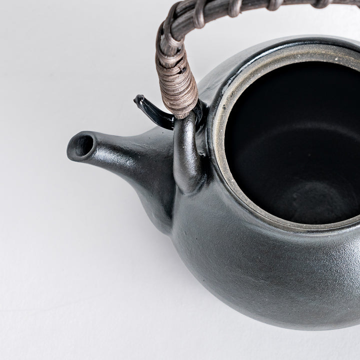 Inside view of the matte black teapot, featuring the stainless steel strainer for brewing loose leaf tea.