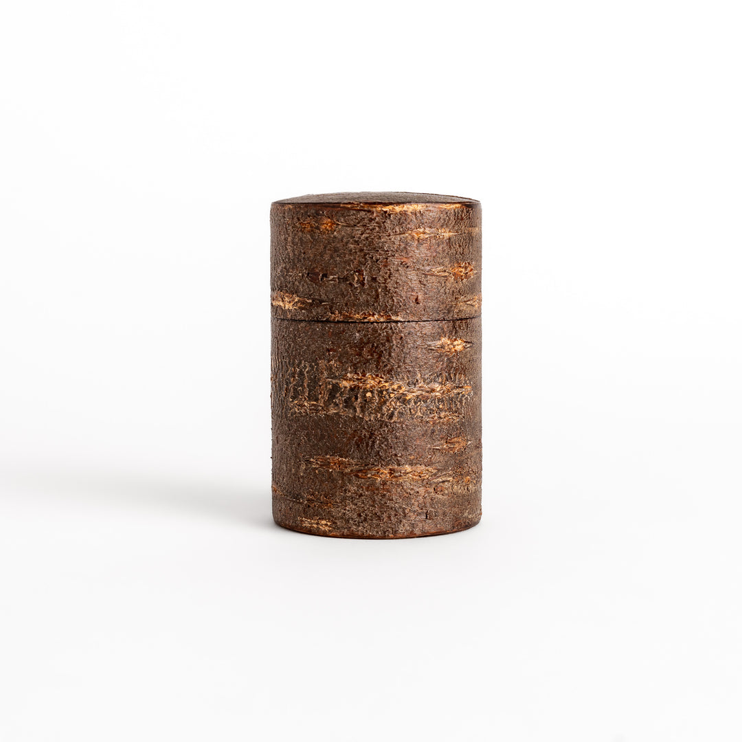 Rustic cherry bark tea canister with a deep brown finish and natural texture, perfect for storing and preserving loose leaf tea.