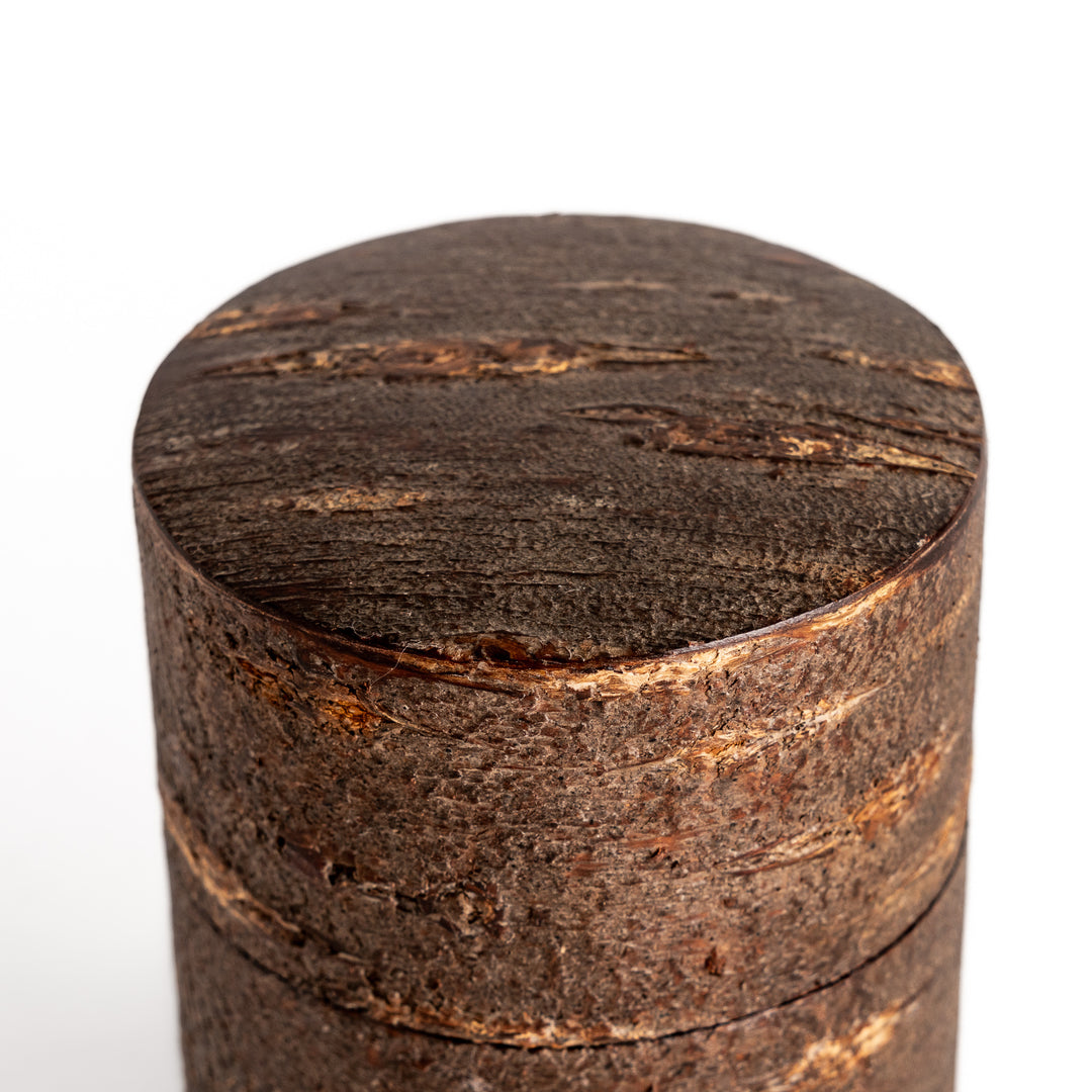 Rustic cherry bark tea canister with a deep brown finish and natural texture, perfect for storing and preserving loose leaf tea.