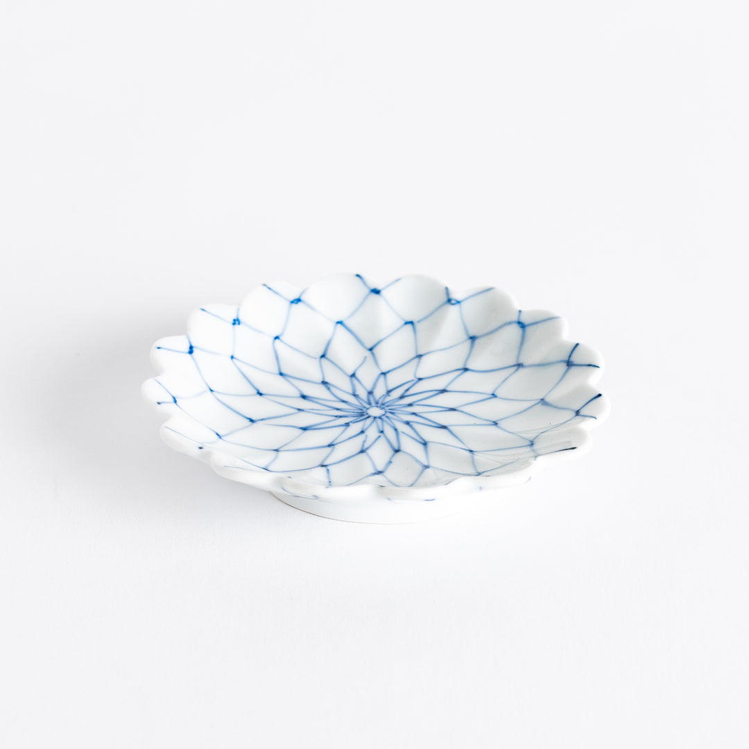 White sauce dish with a blue chrysanthemum mesh pattern and scalloped edges.