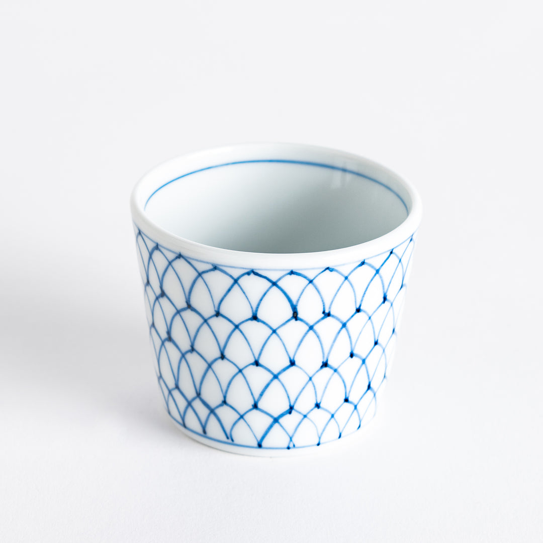 Small white condiment bowl with a blue mesh pattern.