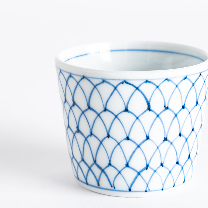 Small white condiment bowl with a blue mesh pattern.