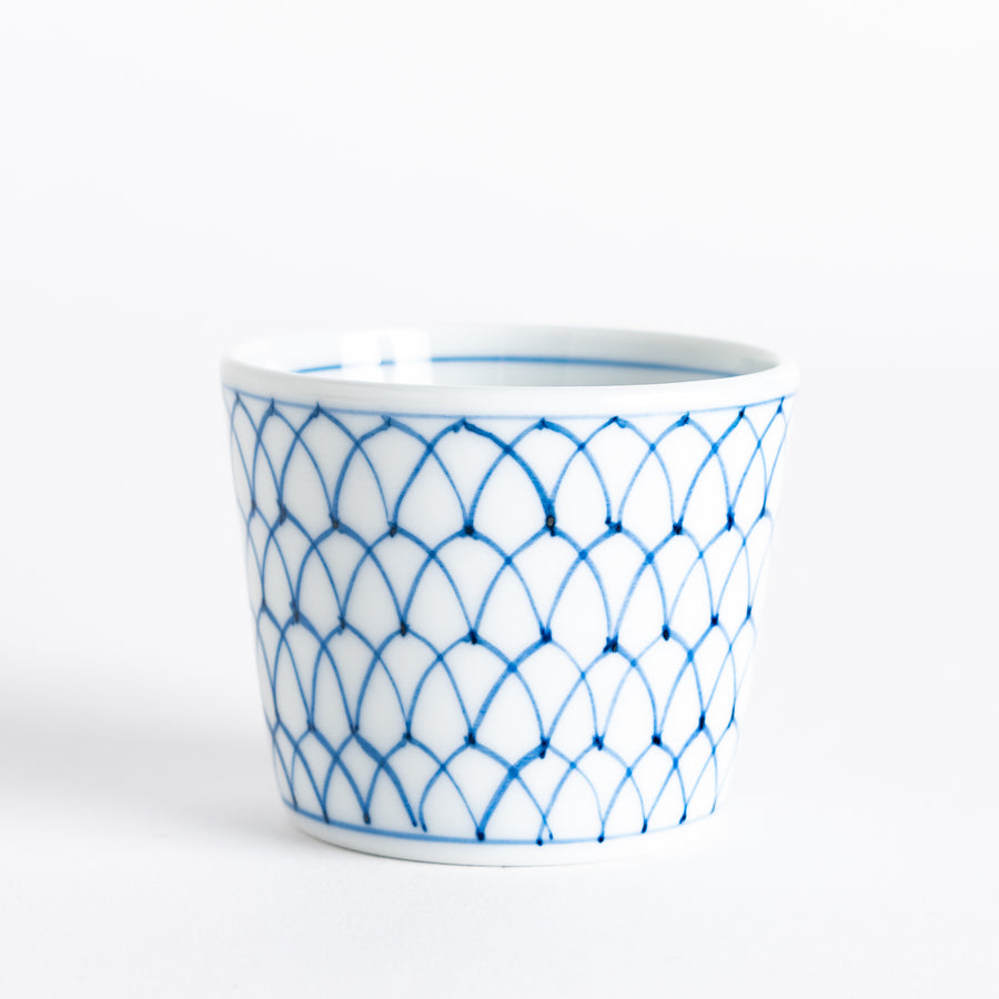 Small white condiment bowl with a blue mesh pattern.