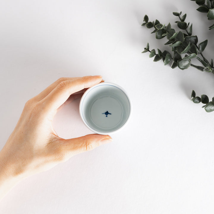 Small white condiment bowl with a blue mesh pattern.