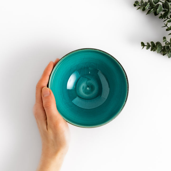 Textured brown Matcha bowl with a bright green interior, handcrafted ceramic for modern tea rituals.