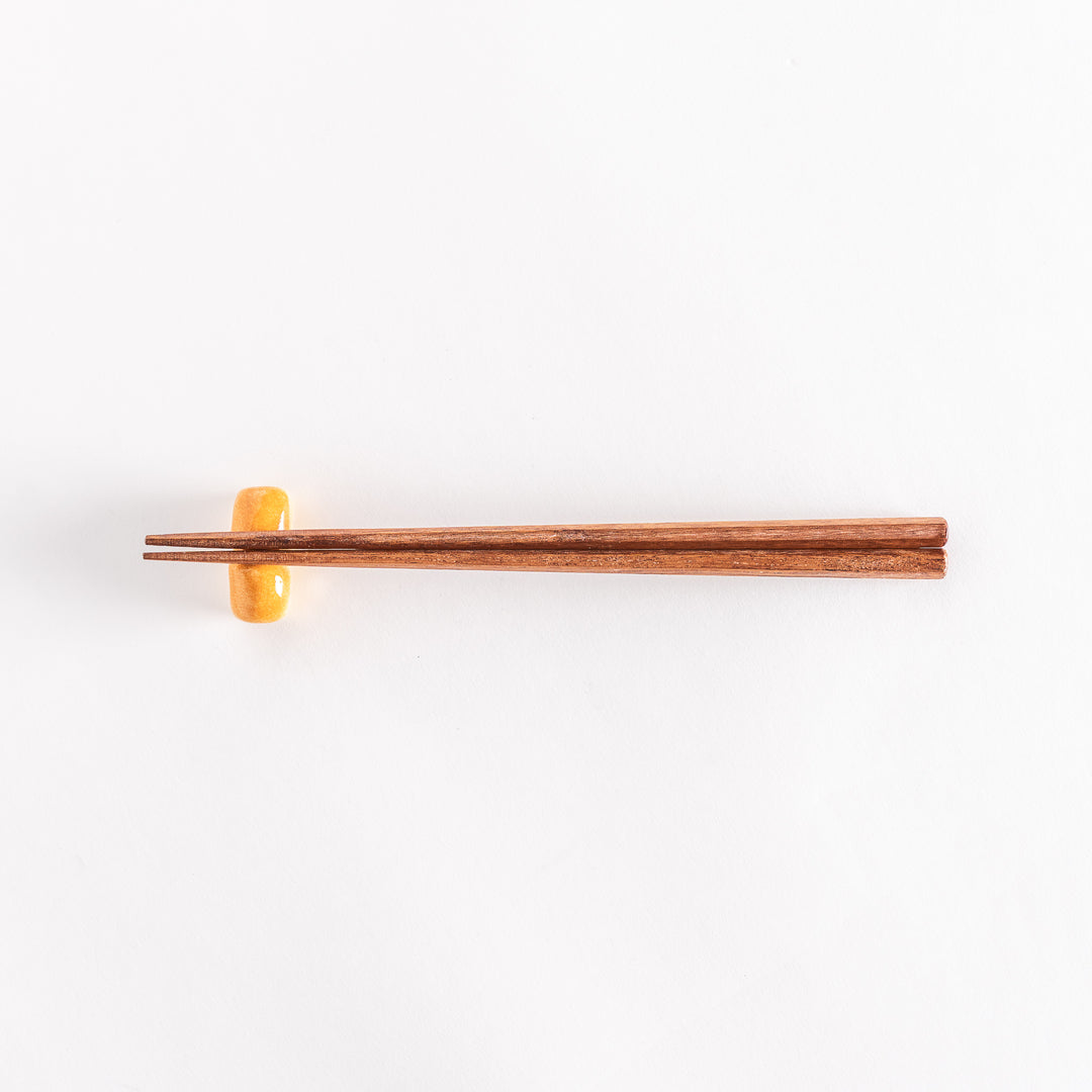 The milk bread chopsticks rest with chopsticks placed across it, photographed to show the full setup.