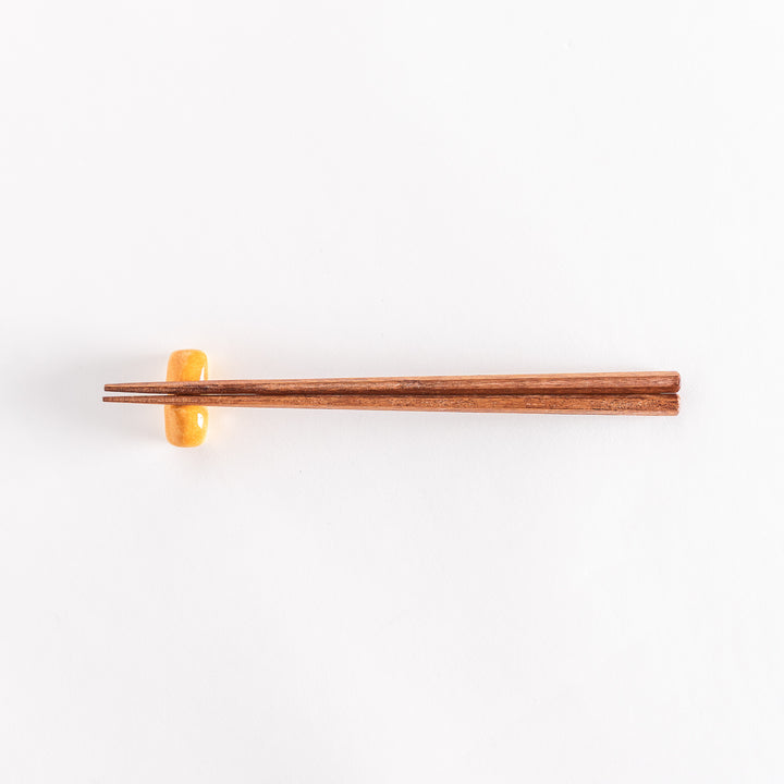 The milk bread chopsticks rest with chopsticks placed across it, photographed to show the full setup.