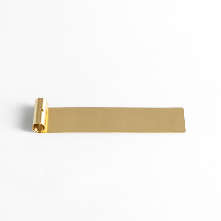 Minimalist brass incense holder with a sleek rolled-edge design, securely holding a single incense stick while the flat base catches falling ash.