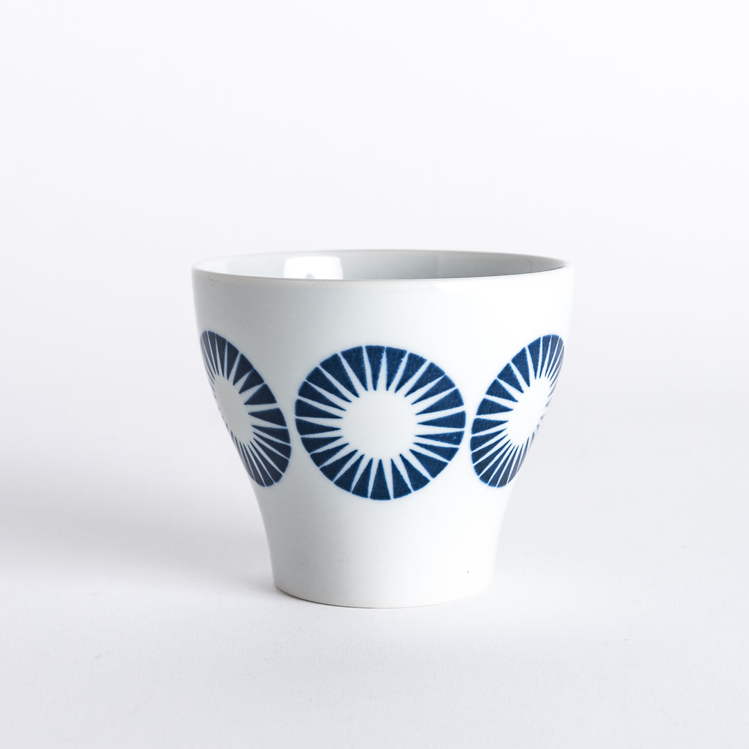 Side view of the Modern Indigo Circle Cup, featuring a series of bold navy blue radiating circles around the cup's body.