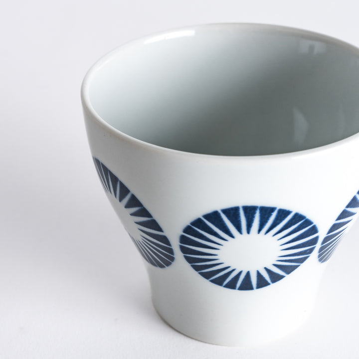 Close-up of the Modern Indigo Circle Cup's bold navy blue radiating circles, emphasizing the fine porcelain texture.