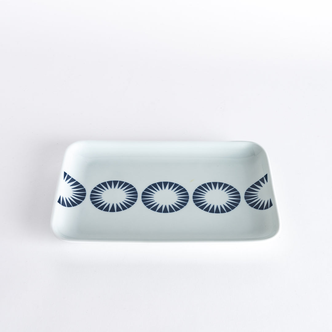 Slightly angled view of the Modern Indigo Circle Dinner Plate, showcasing the navy blue concentric circle pattern across the white surface.