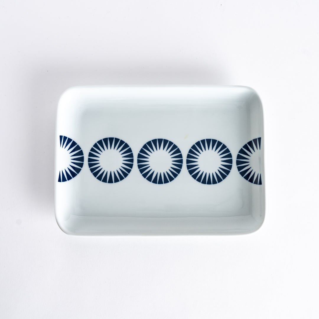 Top-down view of the Modern Indigo Circle Dinner Plate with five bold navy blue concentric circles aligned across the center.