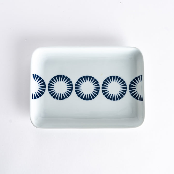 Top-down view of the Modern Indigo Circle Dinner Plate with five bold navy blue concentric circles aligned across the center.