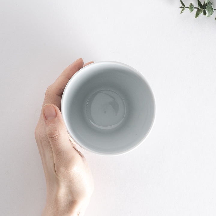 Top-down view of the Modern Indigo Lattice Cup held in hand, showcasing the geometric lattice design and the smooth interior.