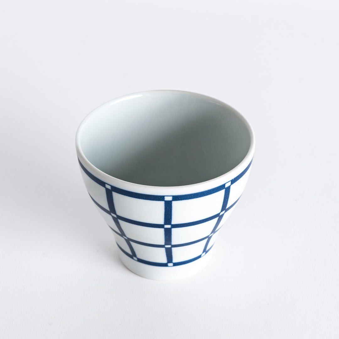 Slightly angled view of the Modern Indigo Lattice Cup, emphasizing the navy blue grid pattern and the curve of the cup.