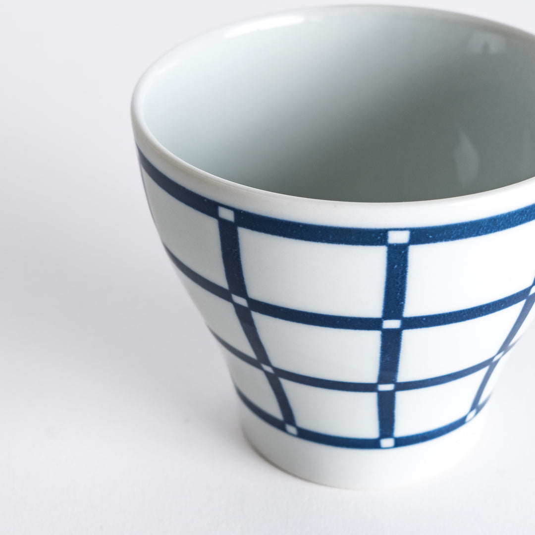 Close-up of the Modern Indigo Lattice Cup, focusing on the sharp, detailed lattice pattern in navy blue on the white porcelain.