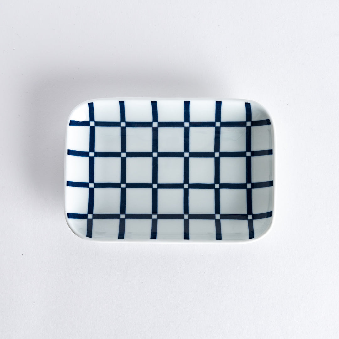 Top view of a rectangular dessert plate with a modern indigo lattice pattern.