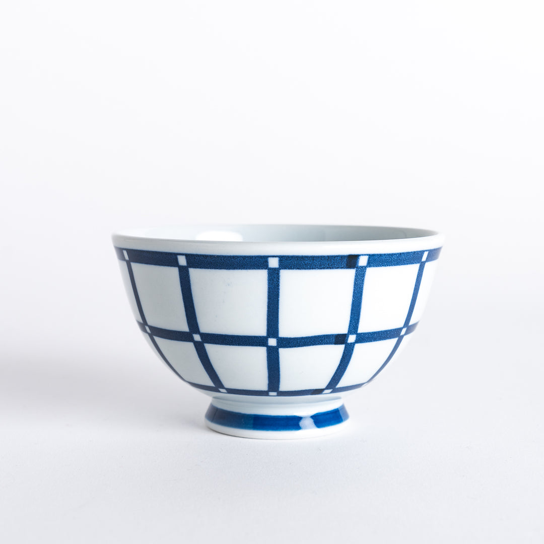 Side view of the Modern Indigo Lattice Rice Bowl, showcasing the navy blue lattice pattern around the bowl's circumference and the blue base.