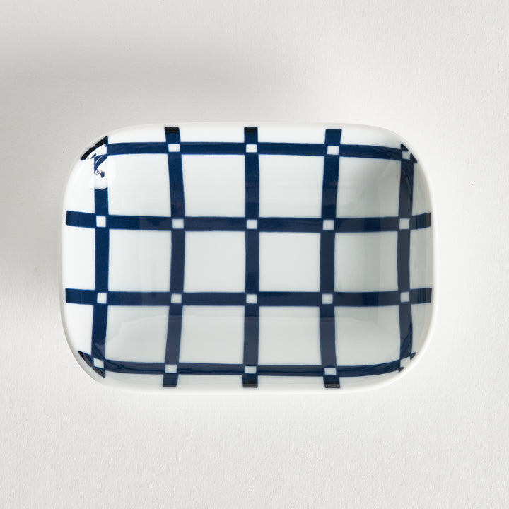 Sauce dish shown from directly above, featuring a navy blue lattice pattern on a white porcelain surface.