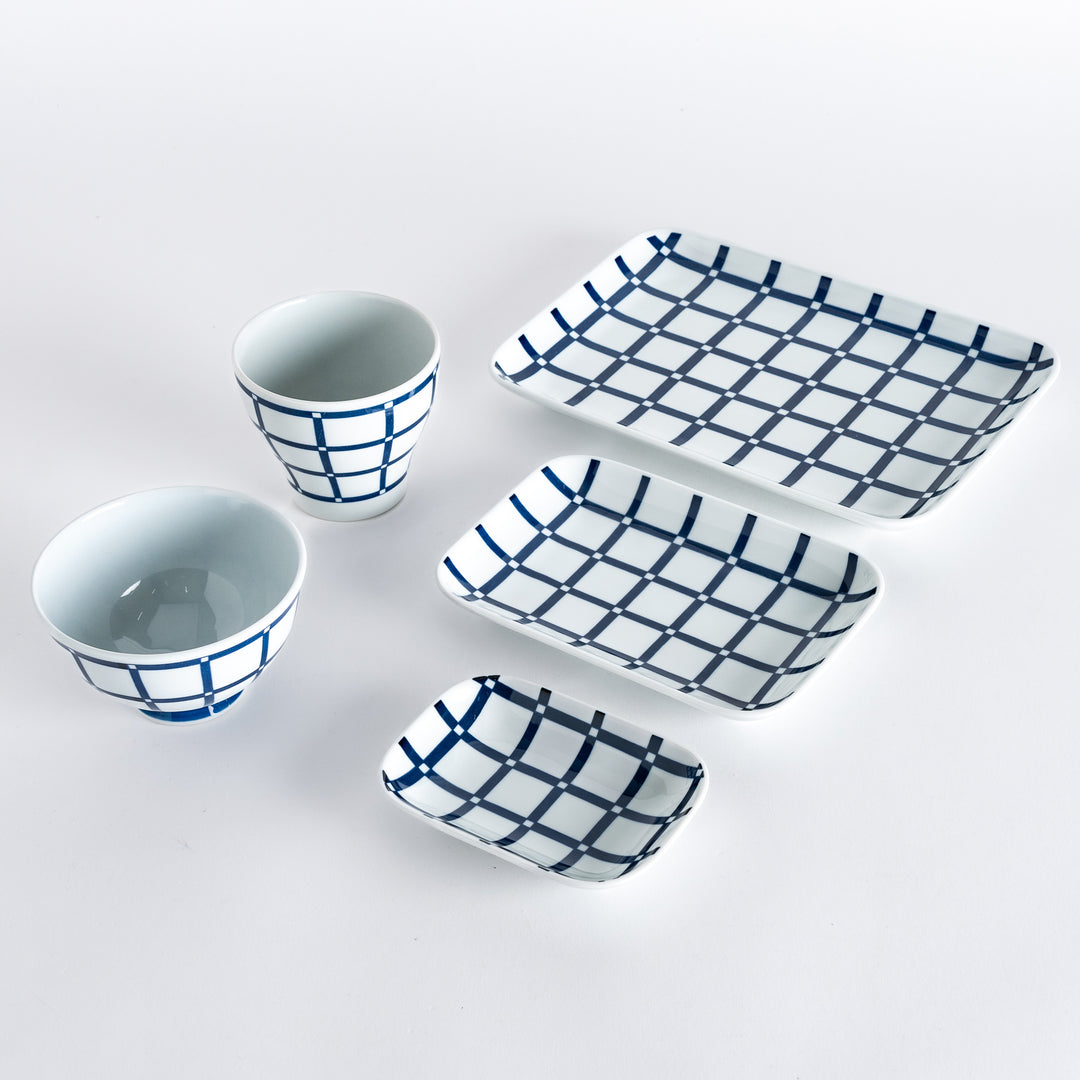 Five pieces featuring the Modern Indigo Lattice design, including two cups, two rectangular plates, and a small dish.