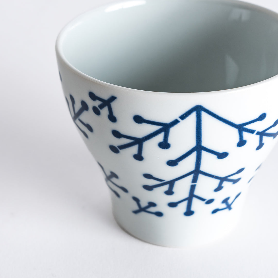 Close-up of the Modern Indigo Pine Cup's navy blue pine branch pattern, emphasizing the intricate design and smooth glaze.