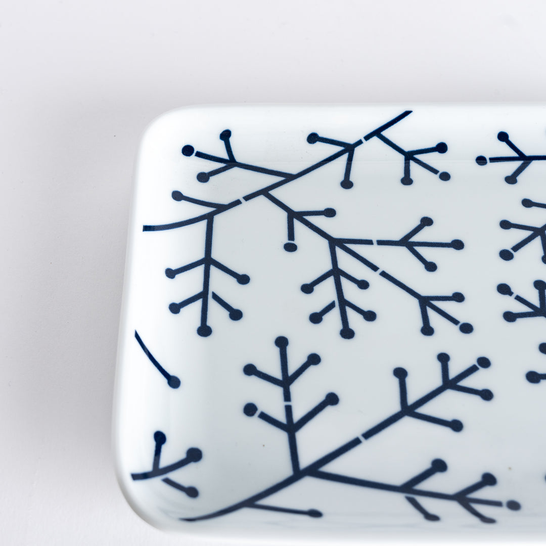 Close-up of the Modern Indigo Pine Dinner Plate, capturing the fine details of the navy blue pine branch design.