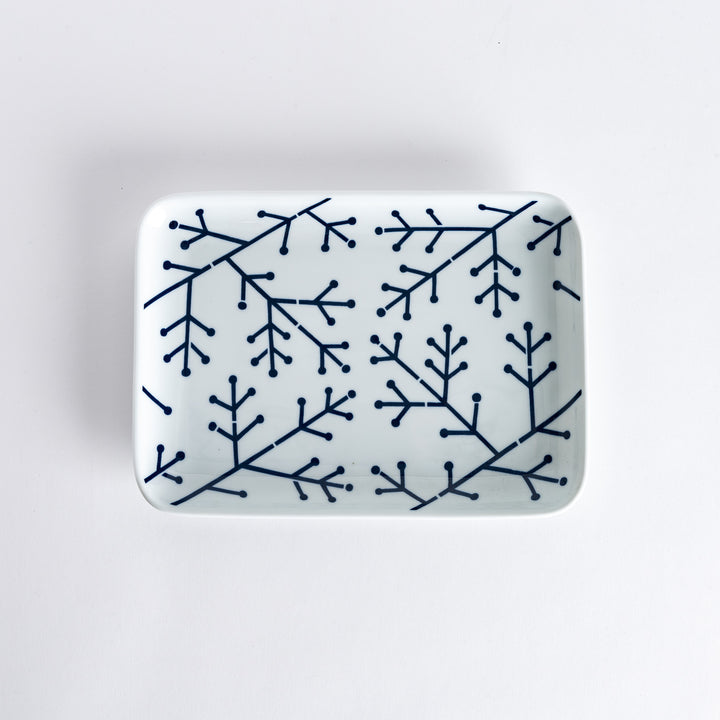 Top-down view of the Modern Indigo Pine Dinner Plate, featuring a navy blue pine branch design on a white background.