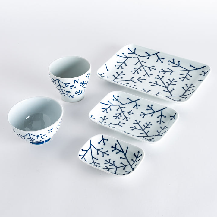 Five pieces featuring the Modern Indigo Pine design, including two cups, two rectangular plates, and a small dish.