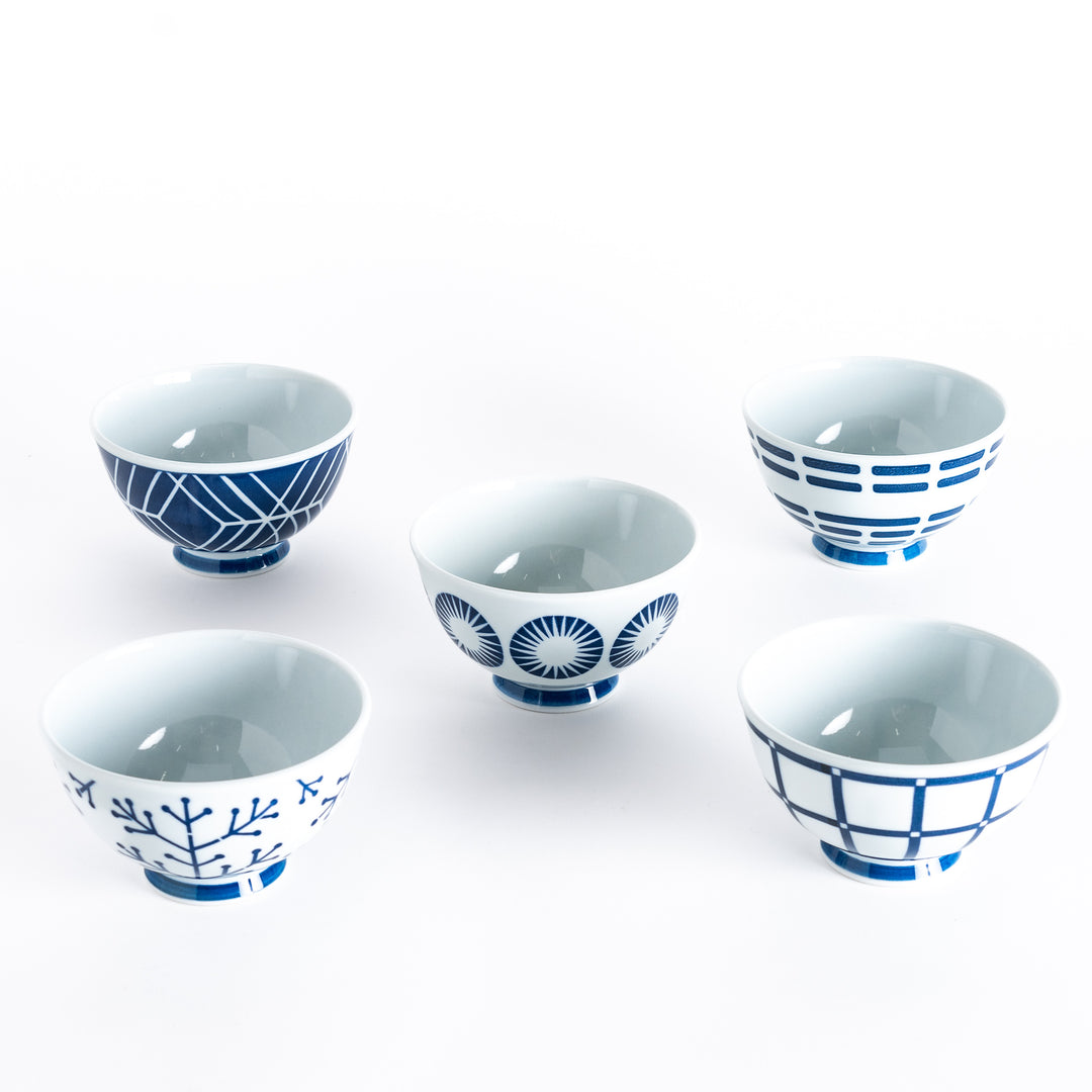 Five rice bowls with navy blue geometric patterns including crisscross lines, radiating circles, and stylized branches.