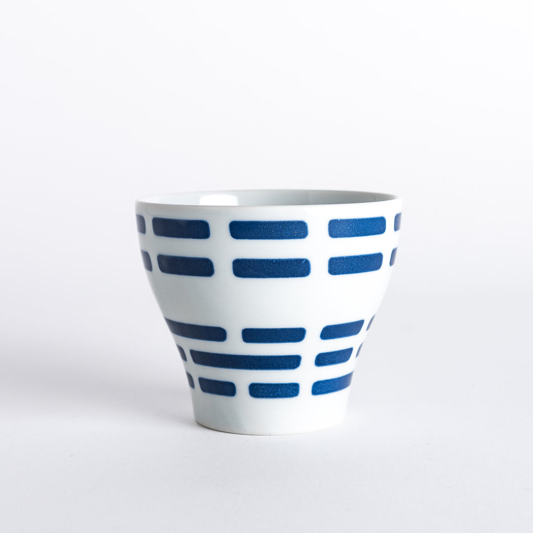 Modern Indigo River Cup with horizontal navy blue stripes on a white background. Flared shape offers a sleek design for versatile use.