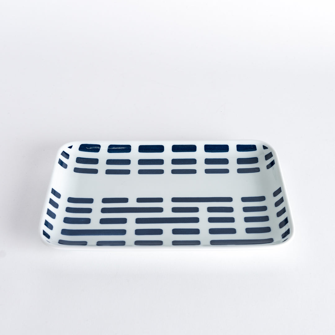 Slightly angled view of the Modern Indigo River Dinner Plate, displaying the intricate geometric pattern and clean lines.