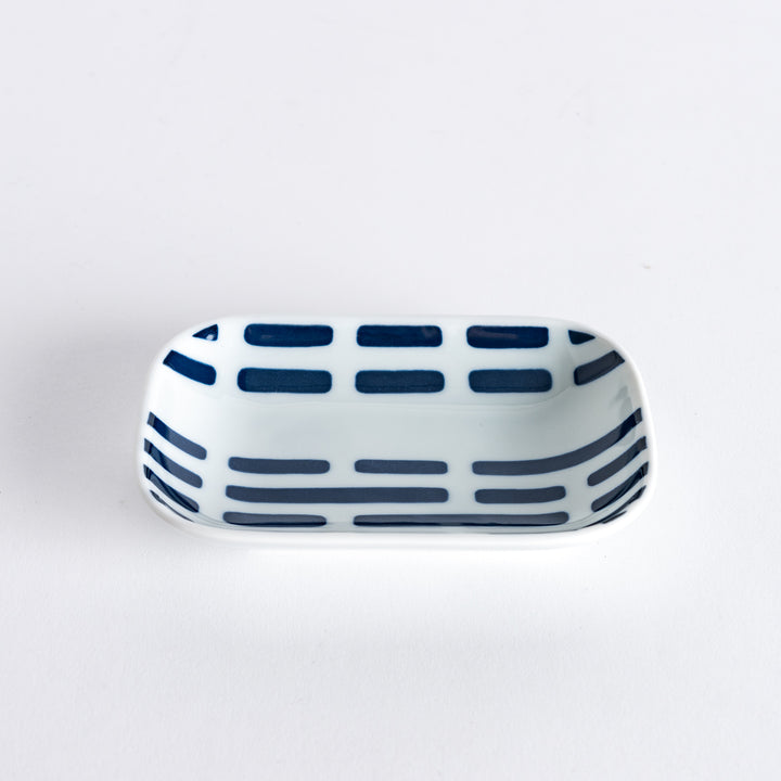 A slightly angled view of the Modern Indigo River Sauce Dish with blue striped patterns.