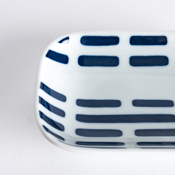 A close-up view of the Modern Indigo River Sauce Dish, focusing on the blue striped patterns.