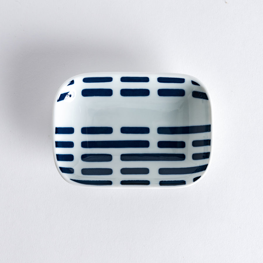 Modern Indigo River Sauce Dish, featuring a rectangular white dish with blue striped patterns on the surface, shot from a top-down angle