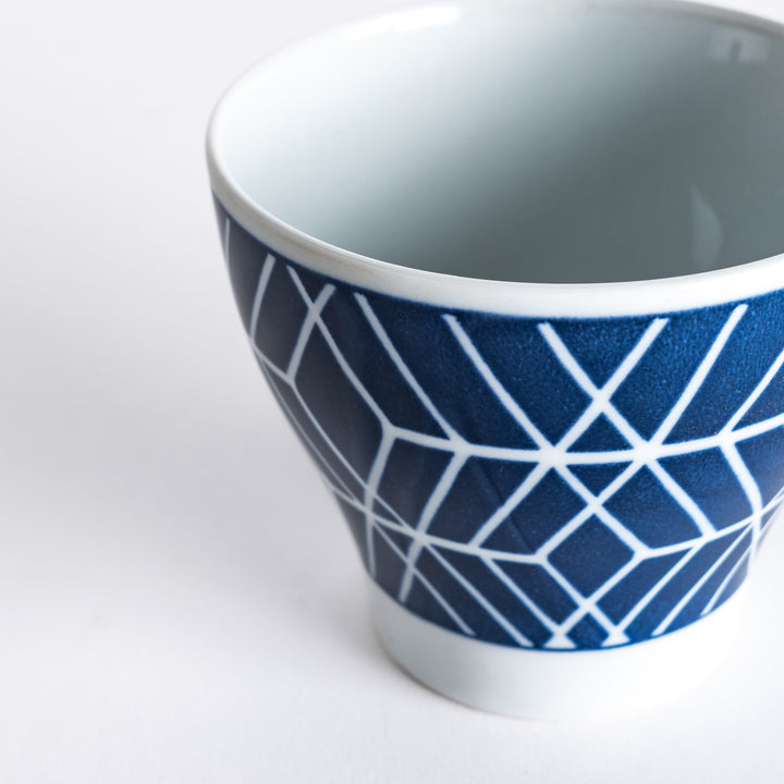 Close-up of the Modern Indigo Tile Cup, highlighting the sharp, white geometric design against a deep blue base.