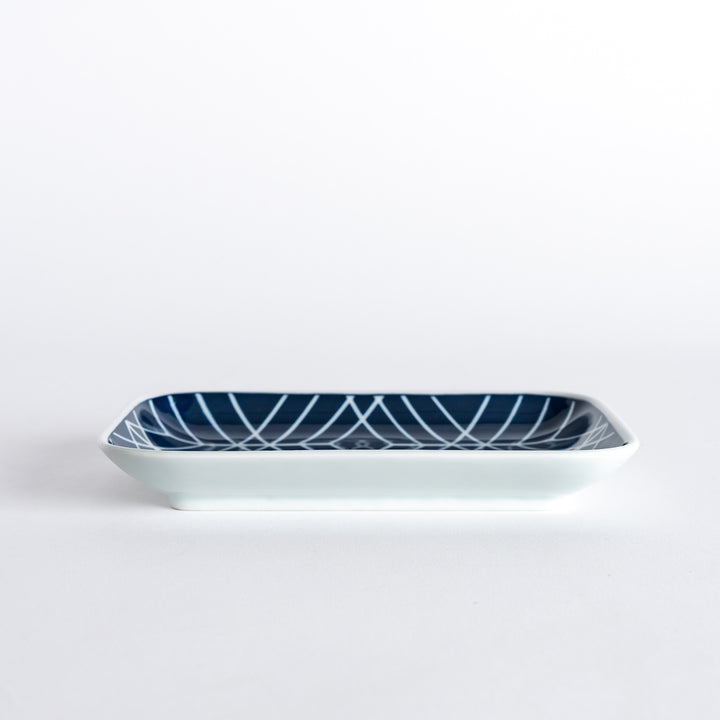 Side view of the Modern Indigo Tile Dessert Plate, highlighting its subtle depth and geometric pattern.