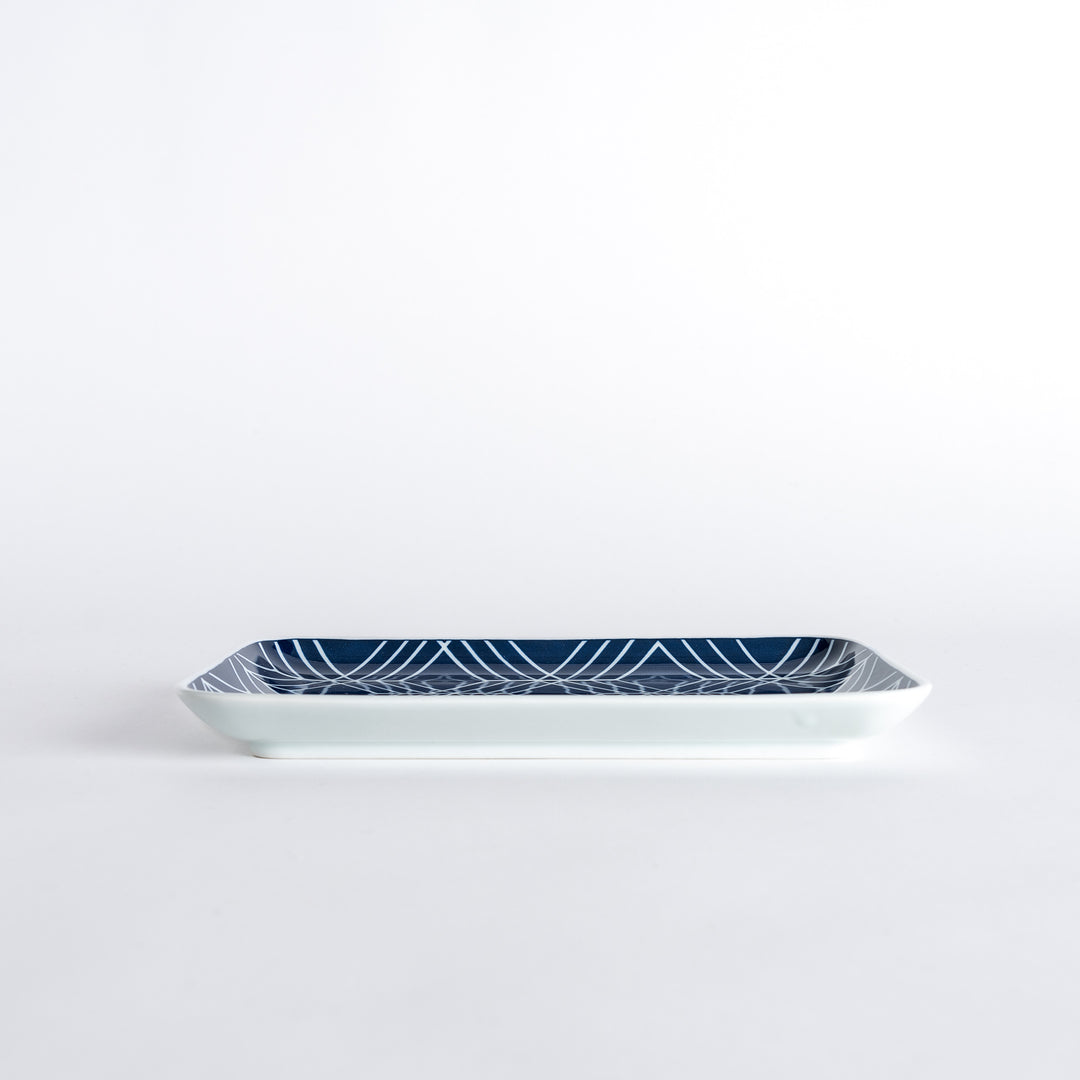 Side view of the Modern Indigo Tile Dinner Plate highlighting its slim profile and glossy finish.