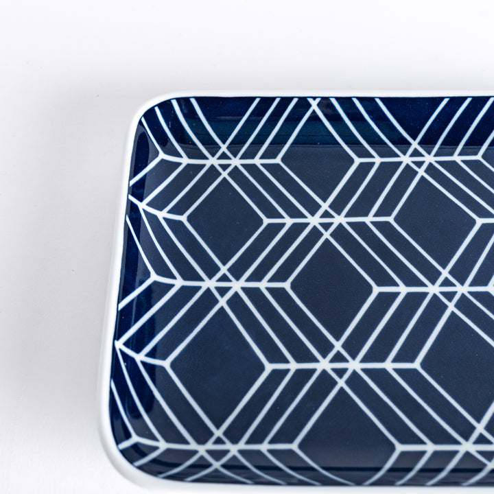 Close-up of the Modern Indigo Tile Dinner Plate showcasing intricate white diamond patterns on the textured navy surface.