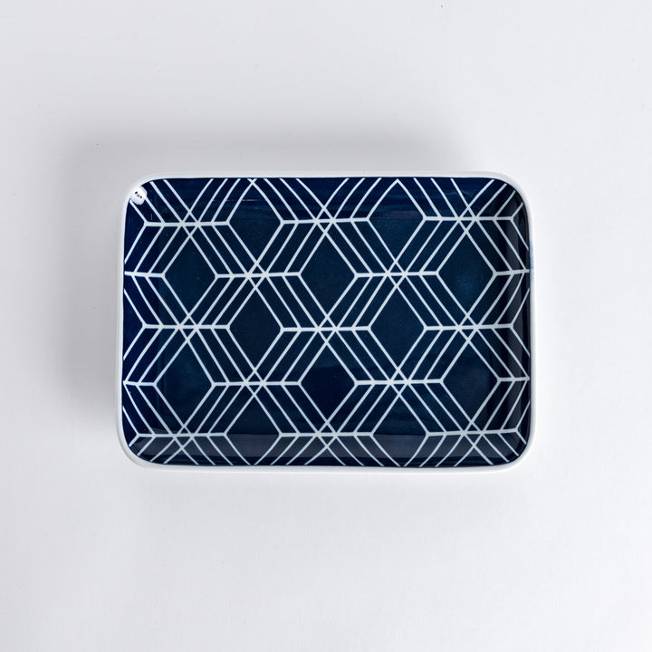 Modern Indigo Tile Dinner Plate featuring a geometric pattern of white lines forming interlocking diamond shapes against a deep navy blue background.