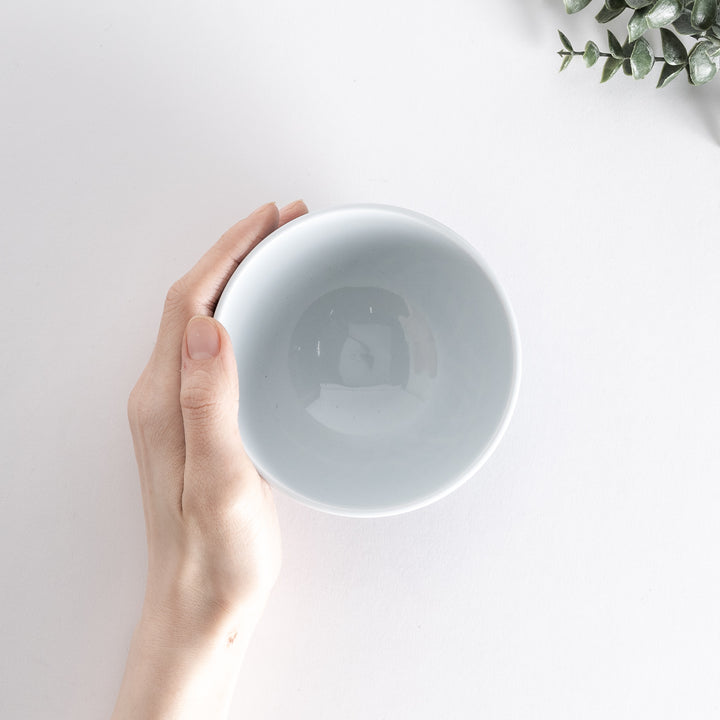 Slightly angled view of the Modern Indigo Tile Rice Bowl, highlighting its geometric navy blue pattern and the blue base.