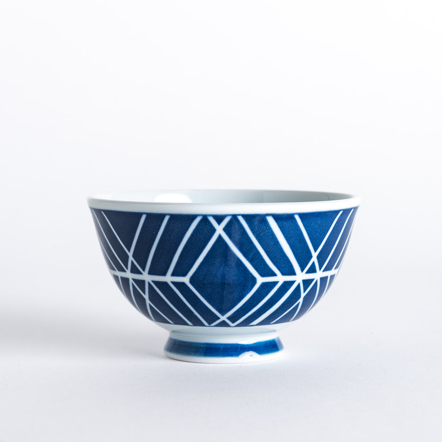 Side view of the Modern Indigo Tile Rice Bowl, featuring a navy blue geometric pattern with intersecting lines, and a blue base.