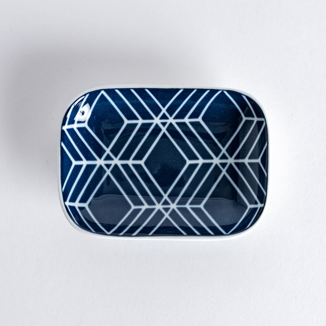 Sauce dish shown from directly above, featuring a navy blue lattice pattern on a white porcelain surface.