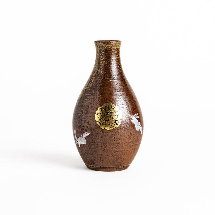 Brown ceramic sake carafe with a decorative rabbit and moon design, perfect for serving sake and adding a touch of traditional Japanese style to your table.